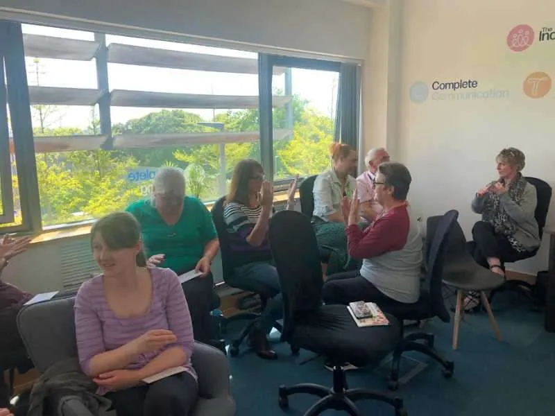 Group of people learning British Sign Language